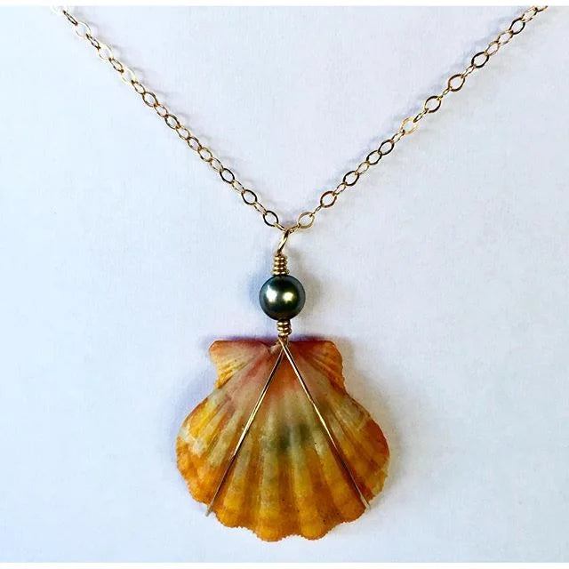 Sunrise Pūpū necklace with a natural golden scallop shell pendant and Black Tahitian pearl on a gold-filled chain.