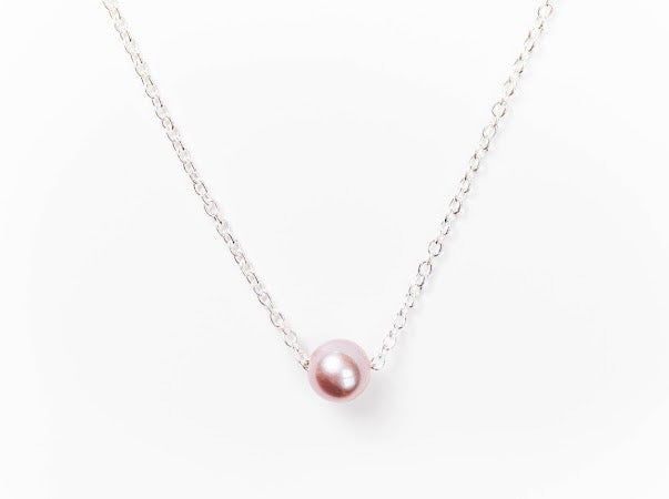 Single pink Edison pearl necklace on a fine silver chain against a white background.