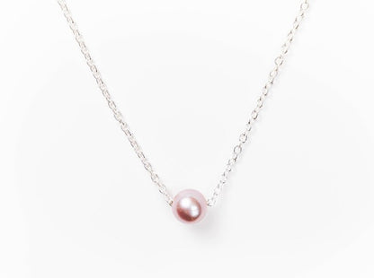 Single pink Edison pearl necklace on a fine silver chain against a white background.