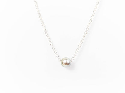 Silver Tahitian pearl necklace on a fine silver chain against a white background.